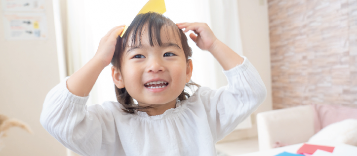 A toddler smiling while playing in the living room