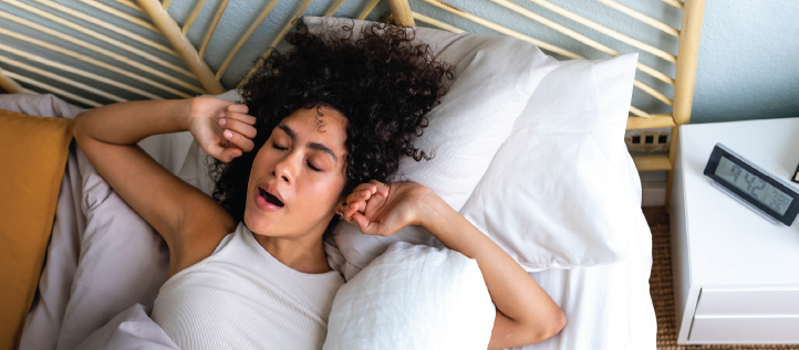 A young woman waking up in the morning and yawning