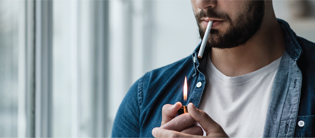 A man lighting a cigarette