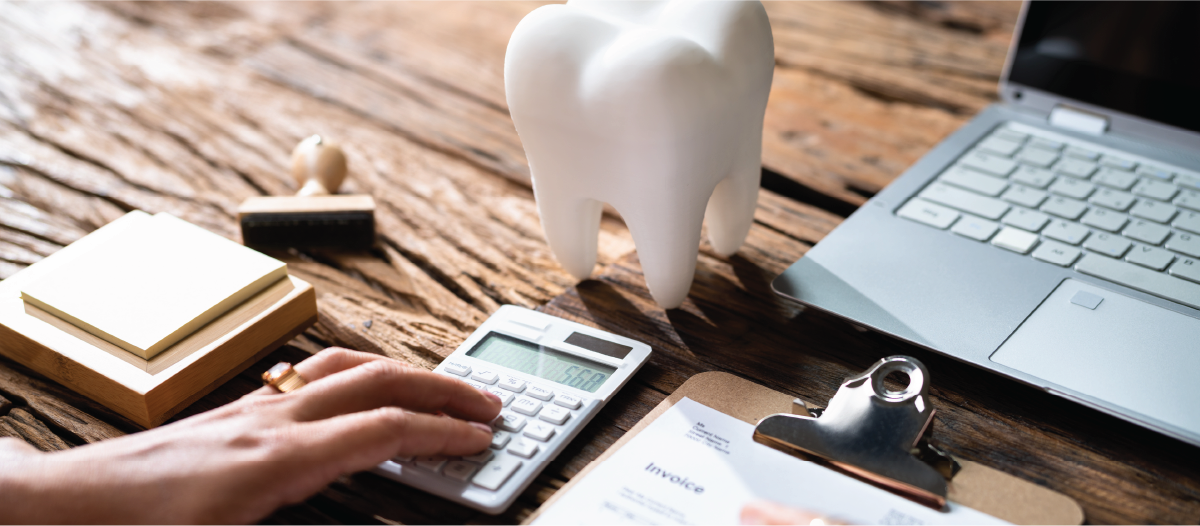 A person calculating dental costs and coverage