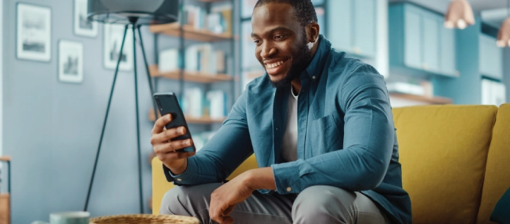 Young man smiling at phone