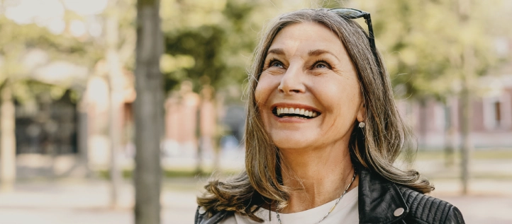 Older woman smiling after a root canal procedure