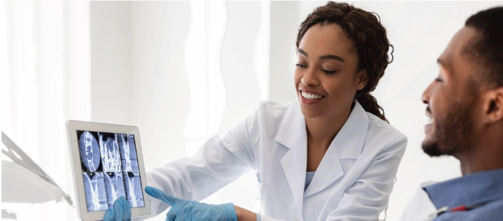 Dentist going over x-rays with patient before a dental crown procedure