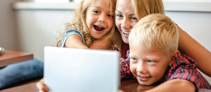 Woman with her two kids using a tablet