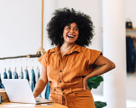 Self employed woman smiling in her store