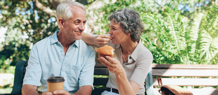 Senior couple outside sitting on a bench