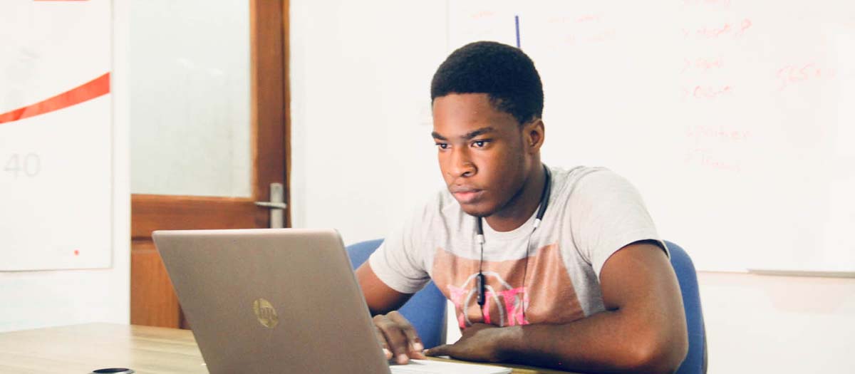 Young man looking intently at laptop