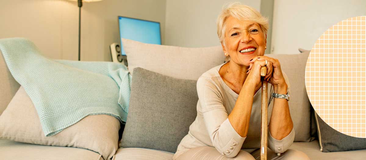 Senior Woman Sitting On Couch Smiling