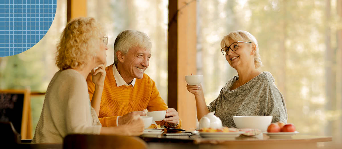 Three retired people having coffee and morning snacks