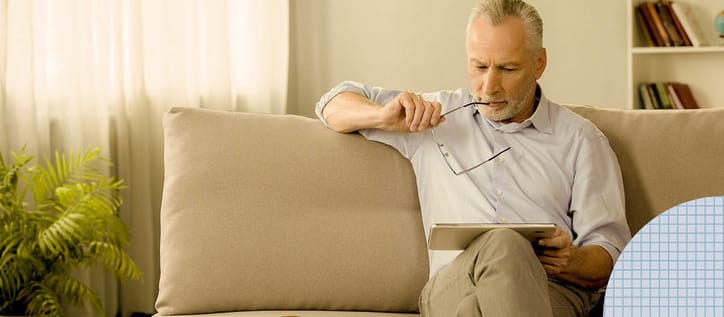 Man looking at iPad pensively