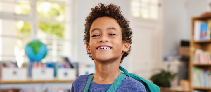 Young boy smiling at school