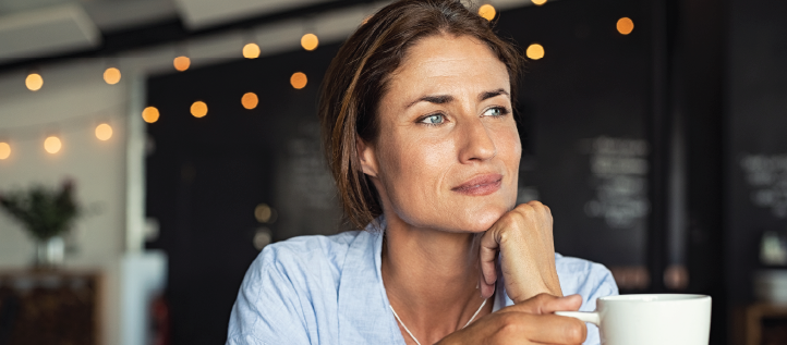 A woman drinking coffee at a coffee shop