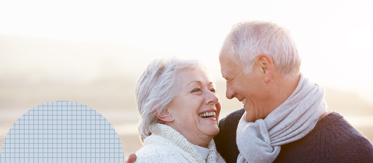 senior couple looking smiling affectionately