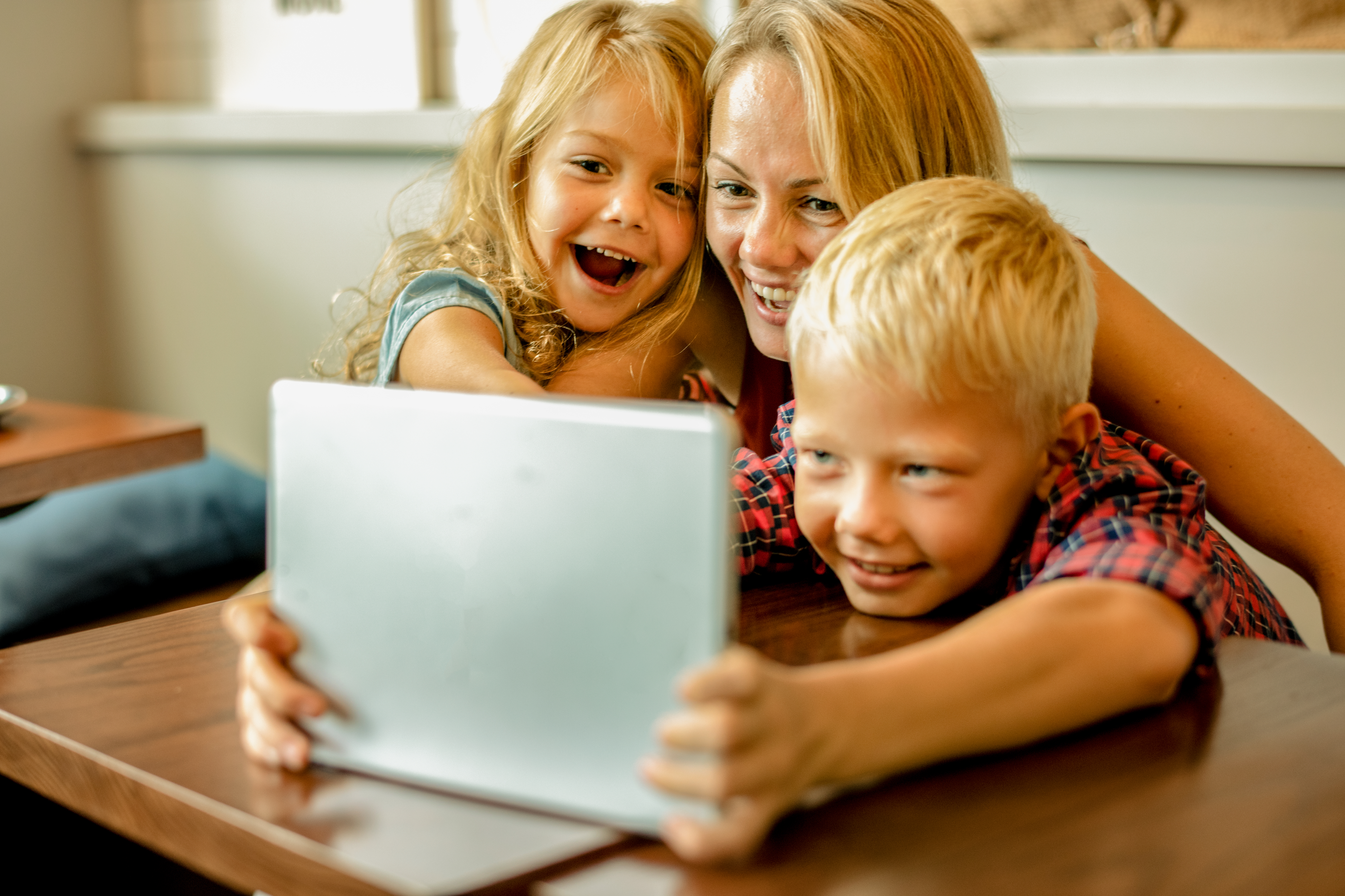 Mom and her two kids smiling and laughing